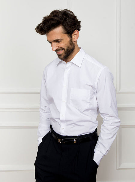Man wearing white long sleeved shirt made with 100% Royal Oxford Cotton.